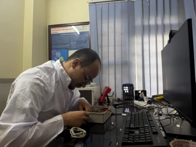 Hands-on assembly and testing of the ESP32-based environmental monitoring sensor prototype, integrating dust, temperature, humidity, pressure, and power management components inside the device enclosure.